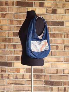 Handmade hobo style purse/sack.  This shoulder bag is made from cotton polyester fabric, outer shell is a light weight blue denim fabric.  The lining of the bag is a white medium weight fabric with a dotted hexagon design in turquoise, orange and navy blue .    The hexagon design pocket on the denim side is 2 1/2" from the top of the bag, measuring 8 1/2" wide and 54" deep, sewn in the middle making one side 4 1/4" wide, the other side measures 3" wide with a 1 1/2" space for a pen or lip gloss. Cotton Hobo Bag With Pockets, Daily Use Hobo Bag With Pockets, Casual Cotton Hobo Bag With Removable Pouch, Bohemian Reversible Hobo Bag For Everyday Use, Cotton Hobo Tote Bag With Pockets, Blue Cotton Hobo Shoulder Bag, Casual Reversible Hobo Bag For Travel, Blue Hobo Bag For Daily Use, Blue Cotton Hobo Bag For Everyday Use