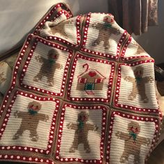 a crocheted afghan with dogs on it