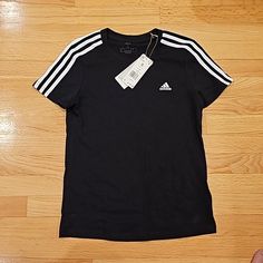 Brand New With Tags Women Adidas Black T-Shirt Size Small Casual Black T-shirt With Three Stripes, Adidas Basic T-shirt With Three Stripes, Basic Adidas T-shirt With Three Stripes, Black Cotton T-shirt With Three Stripes, Black Cotton Top With Three Stripes, Black Cotton Tops With Three Stripes, Black T-shirt With Three Stripes, Black Crew Neck T-shirt With Three Stripes, Black Three Stripes Crew Neck T-shirt