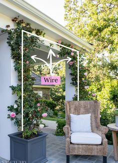 a chair sitting on top of a patio next to a planter filled with flowers