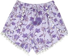 A comfortable fun summer cotton shorts with a cross-cut design and beautiful floral print in lavender.  These shorts have cute little white pom poms and two bigger lavender pom poms attached at the ends of the drawstring; the string of poms give way to reveal the sides. #tlb #JuniorPetite #Yoga #vacationclothing #beachwrap #Floral #Printed #HippieShorts #BeachShorts #FloralShorts Cute White Pajama Shorts For Vacation, Cute White Vacation Pajama Shorts, Lavender Cotton Shorts For Spring, Spring Lavender Cotton Shorts, Cute Spring Vacation Pajama Shorts, Lavender Bottoms For Summer Vacation, Lavender Beach Bottoms For Spring, Purple Shorts For Spring Loungewear, Summer Purple Lounge Shorts