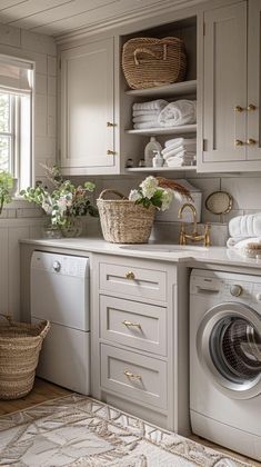 a washer and dryer sitting in a room next to a window with baskets on it