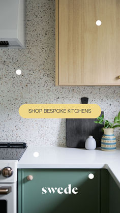 a kitchen with green cabinets and white countertops has the words shop bespoke kitchens above it