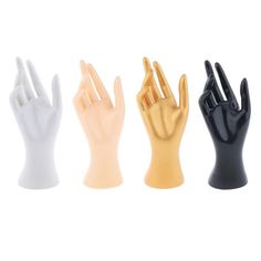 three different colored plastic hand models on a white background, one is black and the other is gold