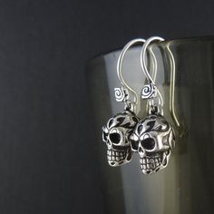 "If my Tribal Skull Earrings were a song, that song wouldn't be \"Kumbaya\", that's for damn sure. Shy, retiring type? Hunting on Etsy for the perfect earrings for your bridesmaids? Something for Granny maybe? If these don't do it for you then Granny's just gonna have to wait 'till next year. Never too late for a bit of rock n roll. In fact I just had an irresistible urge to put some AC/DC on and shotgun a beer. These earrings'll do that to you. Cast in solid white bronze, and thickly silver pla Earrings Antique, Skull Earrings, Never Too Late, Antique Earrings, Ac Dc, A Song, Rock N, Too Late, Rock N Roll