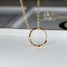 "This Karma Necklace is the perfect addition to your jewelry collection! Available in both sterling silver and gold filled, this necklace features an open circle design that symbolizes the cyclical nature of karma. The hammered texture adds a unique touch of style to the classic eternity necklace, making it a great statement piece for any outfit. Wearing this Good Karma Necklace serves as a reminder to live your life with intention and kindness. Whether you're treating yourself or giving it as a Circular Delicate Chain Jewelry As A Gift, Circular Delicate Chain Jewelry For Gifts, Circular Delicate Chain Jewelry Gift, Sterling Silver Hoop Necklaces In Gold Color, Gold Sterling Silver Hoop Necklaces, Gold Hoop Sterling Silver Necklaces, Dainty Circular Jewelry For Gifts, Gold Hoop Sterling Silver Necklace, Dainty Circle Jewelry Gift