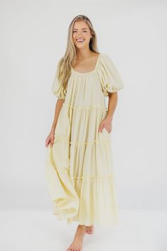 Gently feminine, the Eva Puffed Sleeve Maxi Dress is the perfect choice for the fashion-forward woman. Featuring dramatic balloon sleeves, an elastic neckline for easy wear (and easy nursing!), and tiers of ruffles for a charming yet sophisticated look, this elegant maxi dress is designed with style and comfort in mind. Its relaxed fit makes it a gorgeous choice for expecting mamas. FIT: Runs slightly oversized - very relaxed fit. Your true size will accommodate most baby bumps. MATERIAL: 91% Polyester 9% Spandex. Hand wash cold, line dry, low iron. Or, dry clean. GARMENT DETAILS: Maxi dress with balloon-style short sleeves, elasticized neckline that can be worn on or off the shoulder, tiered ruffle skirt, and relaxed fit. MEASUREMENTS: Size Length Bust Sleeve Small 48" 17" 13" Medium 49" Billowy Puff Sleeve Dress With Square Neck, Feminine Puff Sleeve Dress Billowy Fit, Feminine Puff Sleeve Loose Fit Dress, Billowy Puff Sleeve Feminine Dress, Voluminous Puff Sleeve Midi Dress With Ruffles, Voluminous Puff Sleeve Dress With Ruffles, Feminine Voluminous Puff Sleeve Dress With Balloon Sleeves, Relaxed Fit Puff Sleeve Dress With Gathered Sleeves, Voluminous Puff Sleeve Summer Dress With Balloon Sleeves