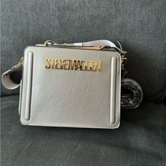 This Is A Very Hard To Find Limited Edition Steve Madden Bev. This Bag Is Sliver Metallic Bag With Gold Metallic Writing. This I Only Have 1 Available The Price Will Be Pretty High. High-end Silver Rectangular Shoulder Bag, Luxury Silver Crossbody Shoulder Bag, High-end Silver Shoulder Bag, Designer Silver Bag With Metal Logo, High-end Silver Shoulder Bag With Silver-tone Hardware, Silver Crossbody Shoulder Bag With Silver-tone Logo, Elegant Silver Bag With Metal Logo, Elegant Silver Bags With Metal Logo, High-end Silver Bag With Silver-tone Hardware