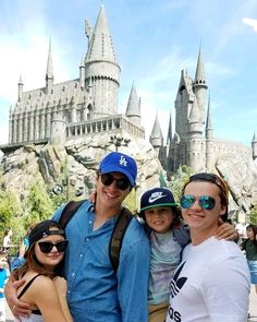 some people are posing in front of a castle