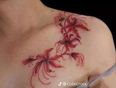 a woman's chest with red flowers on it and the bottom part of her breast