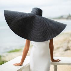 SOLANA Oversized Wide-brim Straw Hat is a statement piece that will keep the spotlight on you while enjoying the sun. Crafted from braided natural straw, the SOLANA hat has an oversized brim guaranteed to provide full coverage from the sun’s harsh rays. Fold the brim as needed to style.DETAILSComposition: 100% Natural StrawsThe brim measures approx 15” in lengthFull hat diameter measures approx 38.5”Slip-on, secure with chin strap Color: Black Designed in California, handmade by artisans in Bali Wide Brim Straw Hat, Enjoying The Sun, Isle Of Man, Independent Designers Fashion, British Indian, Wide Brimmed, Black Media, Black Design, Haiti