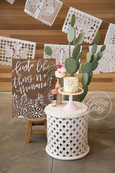 a table topped with a cake next to a sign