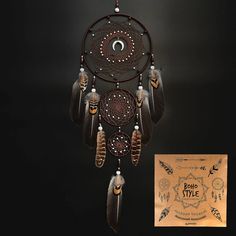 an image of a dream catcher with feathers on it