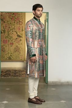 Emerald green sherwani with floral and geometric motifs in a mosaic patterned base, highlighted by placed embroidery. Comes with inner kurta and churidar. - Aza Fashions Fitted Green Bandhgala With Naqshi Detailing, Fitted Green Bandhgala With Naqshi, Designer Green Kurta For Festive Occasions, Festive Pista Green Sherwani With Naqshi, Green Bandhgala With Naqshi For Festivals, Designer Festive Pista Green Sets, Festive Green Bandhgala With Naqshi Detailing, Festive Green Bandhgala With Naqshi, Green Nehru Jacket With Zari Work For Reception