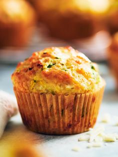 a muffin sitting on top of a table next to some other muffins