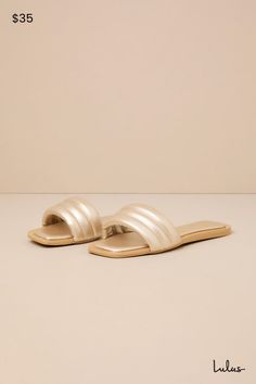 Keep it simple but make it luxe with the Lulus Ameeria Champagne Flat Slide Sandals! These must-have sandals have a shiny, faux leather construction that shapes a square footbed and a wide vamp strap with a puffy, quilted-like effect. The simple slide-on design makes for an effortless final finish to your OOTDs! 0. 5" rubber heel. Cushioned insole. Rubber sole has nonskid markings. Man made materials. Imported. Lulus | Ameeria Champagne Flat Slide Sandal Heels. Elegant Gold Slide Sandals, Sleek Gold Sandals For Summer, Chic Flat Sandals With Padded Heel, Sleek Sandals With Cushioned Footbed For Summer, Sleek Cushioned Sandals For Summer, Chic Gold Sandals With Cushioned Footbed, Chic Sandals With Cushioned Footbed And Square Toe, Chic Gold Sandals With Textured Footbed, Simple Sandals