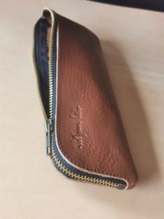 a brown leather wallet sitting on top of a table