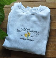 This item is made to order. Please allow 1 week for processing before the item is shipped. State of Blossoms crafts machine embroidered sweatshirts in Bel Air, MD. Please send me a message for custom orders. I'd love to work with you to design something you love. **SIZES ARE UNISEX** Made from a perfectly balanced blend of 50% cotton and 50% polyester fibers, Nublend Jerzees Crewneck Sweatshirts are both comfortable and stylish. This adult, unisex style is light-to-mid weight at 8 oz. Sample col Embroidered Cotton Sweatshirt For College, Cotton Sweatshirt With Machine Embroidery For College, Crew Cotton Sweatshirt With Machine Embroidery, Cotton Crew Sweatshirt With Machine Embroidery, Crew Neck Cotton Sweatshirt With Machine Embroidery, Cotton Crew Neck Sweatshirt With Machine Embroidery, Cotton Sweatshirt With Multicolor Embroidered Text, Multicolor Embroidered Cotton Sweatshirt, Embroidery Crewneck