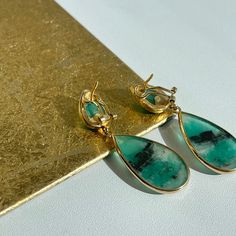 18KT yellow gold + cabochon, bezel set emerald teardrop earrings. Beautiful, unique emeralds were hand picked from Colombia. Measures: 63mm x 19mm 37 CT emeralds Omega backs Fine Jewelry With Cabochon Drop, Fine Jewelry Drop Cabochon, Luxury Teardrop Cabochon Jewelry, Luxury Green Teardrop Earrings, Teardrop Emerald Yellow Gold Jewelry, Emerald Cabochon Earrings As A Gift, Emerald Cabochon Earrings For Gift, Teardrop May Birthstone Earrings, Green Teardrop Jewelry With Bezel Setting