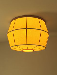 a yellow light hanging from the ceiling in a room