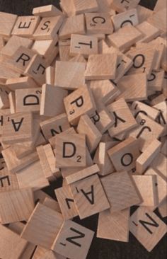 wooden scrabbles with letters and numbers on them