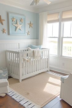 a baby's room with a crib, rocking chair and starfish paintings