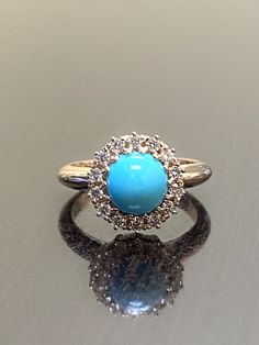 DeKara Designs Custom Order For Joel Our latest design! An elegant Sleeping Beauty Turquoise Halo Diamond Engagement Ring. Metal- 18K Rose Gold, .750. Stones- Center Features an Specially Cut Round Domed Shape 7 MM Turquoise. Diamonds will be F-G Color VS Clarity, number of stones and carat weight to be determined. Total diamond weight 0.36 carats. Art Deco Inspired Handmade Turquiose Halo Diamond Engagement Ring Made in 18K Rose Gold. The turquoise is especially cut for this specific ring and i Elegant Blue Turquoise Ring With Center Stone, Luxury Turquoise Anniversary Ring, Turquoise Blue Diamond Ring With Center Stone, Elegant Turquoise Ring With Halo Setting, Elegant Turquoise Ring With Center Stone, Elegant Turquoise Rings With Halo Setting, Silver Turquoise Ring With Accent Stones For Weddings, Luxury Blue Turquoise Ring For Wedding, Blue Turquoise Ring With Center Stone For Wedding