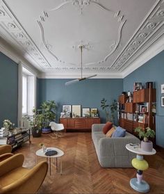 a living room with blue walls and wooden floors