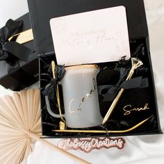 a gift box with a coffee mug and some writing on the side, along with a fan