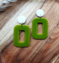 I have hand cast these 1960's mod style earrings in resin, using moss green for the rectangle hoops and  and fixed them to flat white studs.  The hoops measure 30mm x 40mm and the stud tops are 15mm in diameter. The earrings have a total drop of 58mm Lightweight and easy to wear, these colourful geometric earrings will add a burst of colour to any outfit and they will make the perfect gift for lovers of mid century fashion.   You can find more of my 60s inspired geometric earrings here: www.etsy.com/uk/shop/RosieMays?section_id=39023337 Please get in touch if you'd like these in a different colour. Thank you for visiting Modern Green Earrings, Modern Green Rectangular Pendant Jewelry, Handmade Retro Green Jewelry, Retro Rectangular Earrings For Gift, Retro Green Drop Earrings, Handmade Rectangular Retro Jewelry, Rectangular Green Earrings Gift, Green Rectangular Earrings As A Gift, Handmade Green Rectangular Jewelry