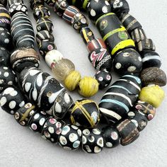 "A strand of various Venetian beads traded to Africa in the late 19th to early 20th century. A good variety of interesting beads in excellent to good condition. Assorted eye beads with a very nice Lewis and Clark bead. A few are chipped or cracked but most are very nice.  Nowadays the pickings are slim in Africa and the strands come with lots of fillers and many with condition issues.  \"As found\" in the marketplace in Upper Volta Over 50 years ago. 75 beads 27\" strand 61cm 6-12mm diameter .8 Antique Multicolor Handmade Beads, Antique Handmade Multicolor Beads, Antique Style Handmade Multicolor Beads, Antique Multicolor Beaded Necklaces, Antique Multicolor Beaded Necklaces With Round Beads, Antique Round Spacer Beads, Antique Oval Beads, Antique Hand-strung Oval Beads, Artisan Black Oval Beads