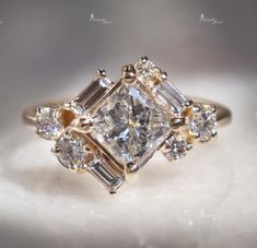 an engagement ring with three stone diamonds on it's sides and two side stones in the middle