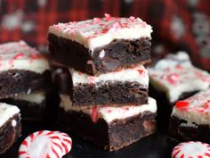 chocolate peppermint brownies stacked on top of each other with candy canes