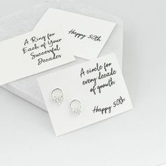 Sterling silver circle earrings displaying five circles, boxed with a message of your choice. These sweet 50th birthday earrings make a fantastic gift for anyone but are especially apt for those celebrating a 50th birthday. Each ring symbolises a decade and there are 4 small and 1 bigger ring all hanging on a circle stud earring. They come with a choice of gift cards or can sit against a velvet backdrop. Placed in a gift box they are ready to be passed on as a gift and you can choose to also hav Silver Jewelry With Message Card For Birthday, Personalized Sterling Silver Earrings For Birthday, Personalized Silver Earrings For Birthday, Personalized Silver Earrings For Birthday Gift, Nickel-free Earrings For Birthday, Silver Earrings For Anniversary, Mother's Day Gift, Silver Earrings For Mother's Day Anniversary Gift, Personalized White Earrings For Anniversary, Velvet Backdrop