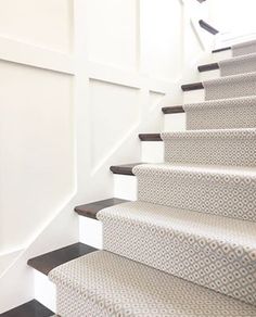 the stairs are lined with patterned carpet