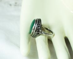 Antique Victorian Malachite Sterling Silver Ring Size 8 Circa 1880s. The Gemstone Is A Highly Polished Malachite Cabochon In A Beautiful Sterling Silver Setting. The Inside Of The Ring Is Enclosed With An Elaborate Filigree Wire Work.  Marked On The Exterior Of The Band, C100, c1887  The Ring Is In Good Condition. This Ring Comes To You In A New Ring Presentation Box. Select Giftwrap At Checkout To Make This A Hassle-Free Gift Giving Experience. Item # X631    CONTINUE SHOPPING Discover Other Fine Collectibles & Antiques https://www.etsy.com/shop/CynthiasAttic/items Antique Hallmarked Turquoise Ring, Antique Cabochon Emerald Ring Gift, Victorian Green Engraved Ring, Antique Turquoise Cabochon Ring For Wedding, Antique Oval Cabochon Emerald Ring, Antique Style Turquoise Wedding Ring With Cabochon, Handmade Victorian Green Rings, Antique Cabochon Emerald Wedding Ring, Victorian Handmade Green Rings