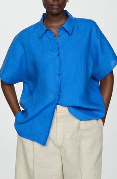 Stay cool throughout the warmer seasons in this lightweight linen button-up perfected by short sleeves and a modern boxy fit. Front button closure Point collar Short sleeves 100% linen Machine wash, line dry Imported Blue Linen Blouse For Vacation, Relaxed Blue Summer Blouse, Summer Flax Shirt With Buttons, Summer Tops In Flax Color With Button Closure, Summer Tops In Flax Color With Buttons, Flax Top With Button Closure For Summer, Summer Flax Tops With Button Closure, Modern Buttoned Tops For Summer, Flax Shirt For Summer Workwear