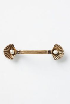 an antique gold brooch with two white pearls