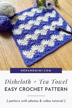 a blue and white crocheted dishcloth with flowers on it