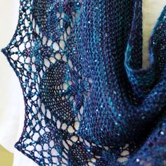 a close up of a knitted shawl on a mannequin neck piece