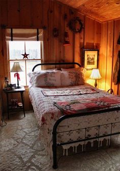 a bed in a room with wooden walls