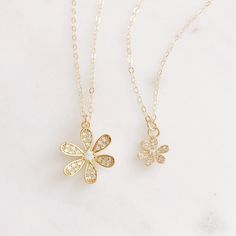 "DESCRIPTION: The LULU Necklace - Opal and cz stone daisy pendant on a dainty gold filled chain. Available in two sizes. We love this flower necklace! MATERIALS: Chain, Clasp, Jump Rings - Gold filled Pendant - Opal and CZ stones set in gold plated PENDANT SIZE: Small: Approximately 7/16\" Large: Approximately 11/16\" MATCHING DAISY EARRINGS: https://etsy.me/2Nl1dRB PACKAGING: Your necklace will arrive on a Dainty Doe signature jewelry card placed in a white jewelry box, with a bow and tag, perf 14k Gold Filled Flower Necklace, Gold Dainty Flower Necklace With Clavicle Chain, 14k Gold Filled Flower Pendant Necklace, Delicate Gold Charm Necklaces With Flower Shape, Delicate Necklace With Flower Charm In 14k Gold Filled, Delicate Gold Flower Necklace With Charm, Delicate 14k Gold Filled Necklace With Flower Charm, Dainty Flower Necklace With Adjustable Chain, Dainty Gold Plated Flower Pendant Necklace