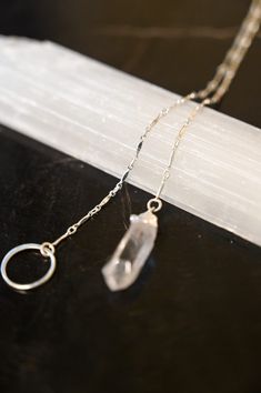 A Quartz necklace unlike any other! This beautiful & timeless Quartz lariat necklace weaves through the circle, allowing you to adjust where the circle sits on your chest. Quartz is the Power Stone, helping you see the Vision you are creating for your life and walk that path with crystal clarity. Pair this gorgeous lariat necklace with our Circle of Life Necklace. Clear Quartz pendant approximately 3/4" in length Sterling silver bar chain and circle ring Necklace is a singular chain without a cl Adjustable Sterling Silver Crystal Necklace, Adjustable Spiritual Lariat Jewelry, Nickel Free Sterling Silver Lariat Necklace, Adjustable Delicate Chain Lariat Necklace, Adjustable Dainty Round Lariat Necklace, Adjustable Round Lariat Necklace With Delicate Chain, Adjustable Round Lariat Necklace In Dainty Style, Spiritual Lariat Necklace With Adjustable Chain, Spiritual Sterling Silver Lariat Necklace Gift