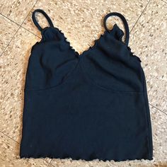 Lightweight Ribbed Cotton V-Neck Tank Top In Black With Spaghetti Straps And Ruffled Trimmings. Fabrics: 100% Cotton Measurements: 15" Length, 11" Bust Made In: Italy Size: Fits Size Xs/S Nwot Black Ruffled Crop Top, Black Ruffle Camisole Top, Black Ruffled Camisole Top, Black Cami Tank Top With Ruffles, Black Ruffled Cami Tank Top, Black Ruffle Cami Top, Black Ruffled Cami Top, Black Spring Top With Ruffled Straps, Black Top With Ruffled Straps For Spring