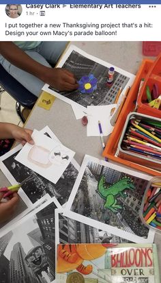 someone is doing something on the table with pictures and crayons in front of them