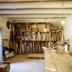 a room filled with lots of different types of woodworking tools on shelves next to each other