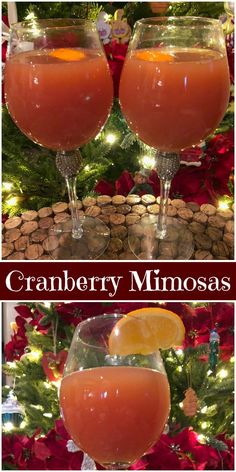 two glasses filled with liquid sitting on top of a table next to a christmas tree