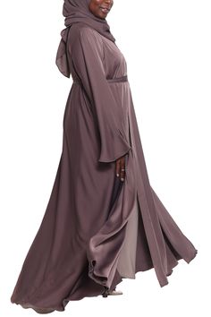 Stunningly gorgeous is how you will look in our lovely Dunya Abaya in Brown Sugar. Made with buttery-soft Nida fabric, Dunya is designed for simple, chic, elegance. The gorgeous A-line sweep gives you an amazing flow while the soft fabric glides beautifully across your skin. You will love this gorgeous piece for all your casual occasions. Made with luxuriously soft Korean Nida Open abaya with hidden buttons Matching shayla (scarf) included Model is 5'5 and is wearing size 58 Made in Dubai Open Abaya, Garment Workers, Chiffon Sleeves, Simple Chic, Over The Top, In Dubai, Brown Sugar, Soft Fabric, Your Skin