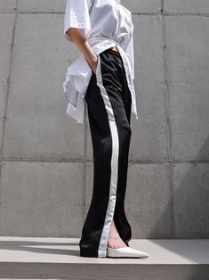 Midweight satin track trouser pants with side stripe in contract color. Straight leg with slight flare at bottom. Model is in MINUSEY S. ✔️ Free worldwide express shipping over $100✔️ Loved by 6,500+ customers✔️ Limited edition collections, maximum style⠀⠀⠀⠀⠀⠀⠀⠀⠀Stay ahead of the trend with can’t-find-anywhere-else staples. Your closet will thank you 💕* MINUSEY S = EU 34, US 2* MINUSEY M = EU 36, US 4* 100% Polyester* Dry clean* Made in Korea - Model Height: 172cm/5'7" (US2, EU34) Pants With Side Stripe, Side Stripe, The Trend, Trouser Pants, Model Height, Straight Leg, Limited Edition, Dry Clean, Track