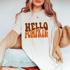 Hello Pumpkin T Shirt, Pumpkin Season, Fall Pumpkin Shirt, Funny Thanksgiving T Shirt, Groovy Halloween, Autumn Vibes, Gift for Thanksgiving We have designed fun, enjoyable and stylish t-shirts to make you happy with small details on Halloween. Don't forget to check out our other t-shirts 😊 ❀DETAIL❀ For printing, we use Bella Canvas and Gildan SoftStyle brand shirts, which are the best in the industry. *Bella Canvas -unisex size -4.2 oz. -Solid colors are 100% Combed Cotton and Ring-Spun Cotton Halloween Cotton Tops With Text Print, Halloween Cotton Top With Text Print, Halloween Text Print Relaxed Fit Top, Halloween Relaxed Fit Top With Text Print, Relaxed Fit Halloween Top With Text Print, Halloween Cotton Slogan Top, Halloween Graphic Tee With Slogan, Halloween Cotton Top With Slogan, Halloween Slogan Graphic Tee